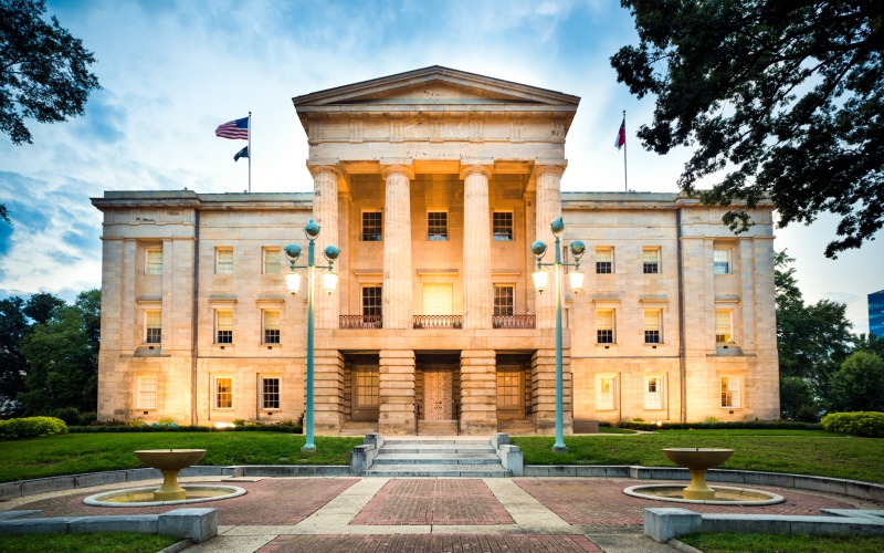 North Carolina State Capitol in Raleigh, where Senate Bill 452 (S.L. 2023-133) and Senate Bill 319 (S.L. 2024-29) were passed, changing UIM and liability auto insurance laws effective July 1, 2025.   Caption: The North Carolina State Capitol in Raleigh represents the legislative origin of sweeping changes to liability minimums and mandatory underinsured motorist (UIM) coverage, enacted under Senate Bill 452 and Senate Bill 319 and taking effect July 1, 2025. 