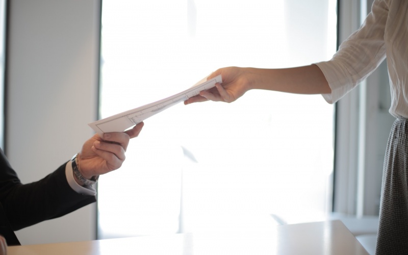 Employee giving paperwork to employer